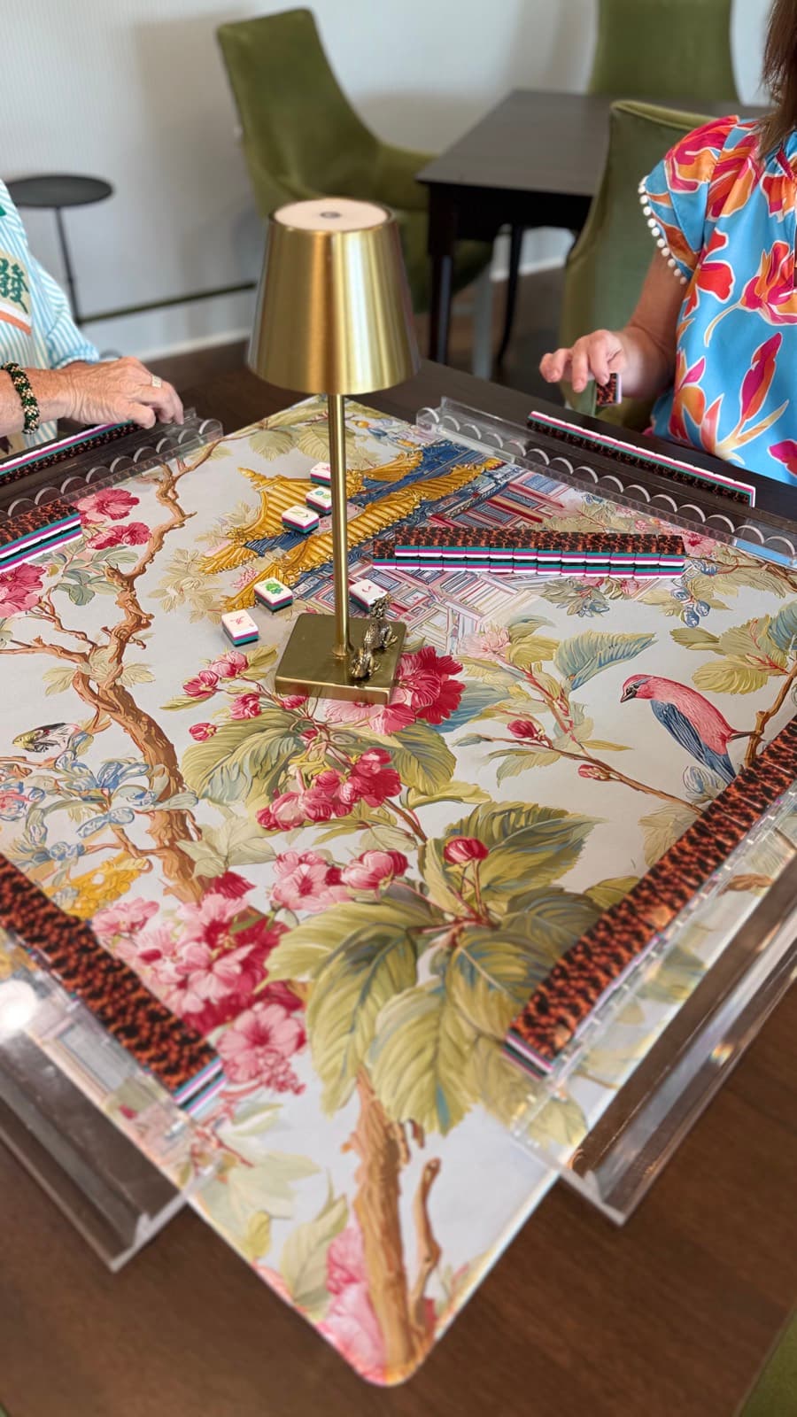 Players enjoying American mahjong at a styled table in Meridian.