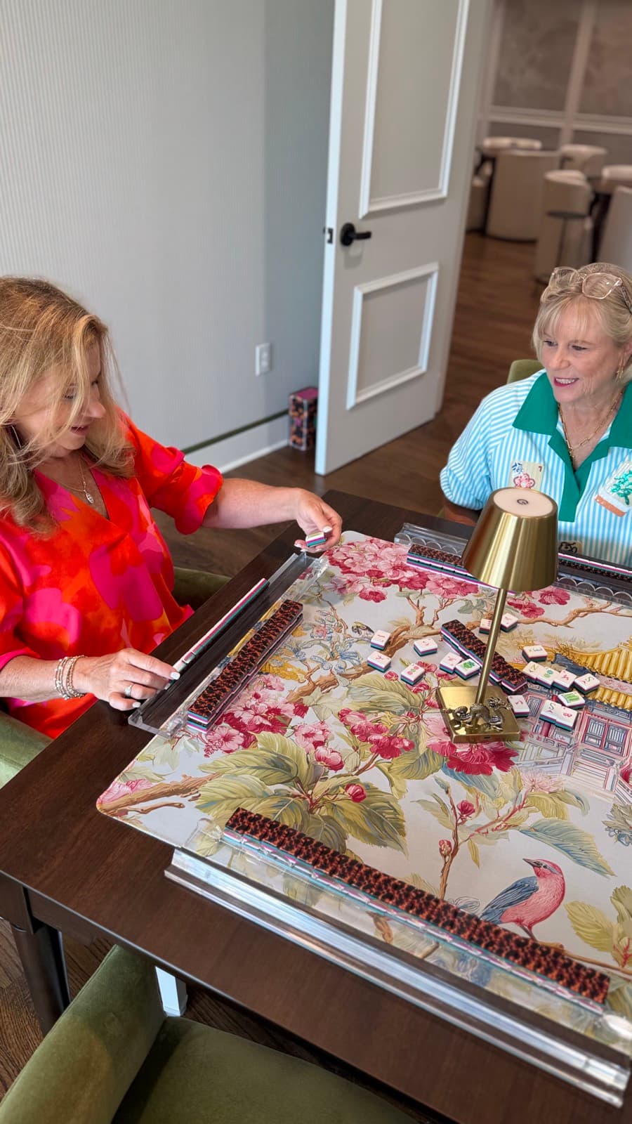 Players enjoying American mahjong at a styled table in Charleston.