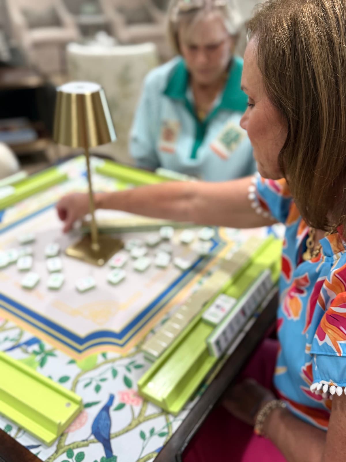 Players enjoying American mahjong at a styled table in Madison.