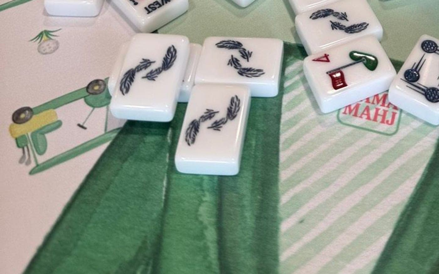 Players enjoying American mahjong at a styled table in San Antonio.