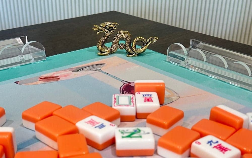 Players enjoying American mahjong at a styled table in Philadelphia.