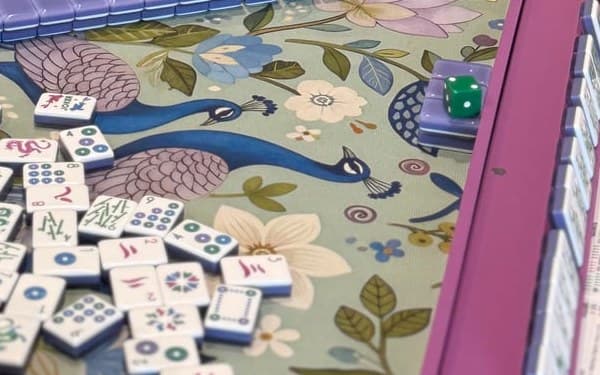 Players enjoying American mahjong at a styled table in Grand Rapids.