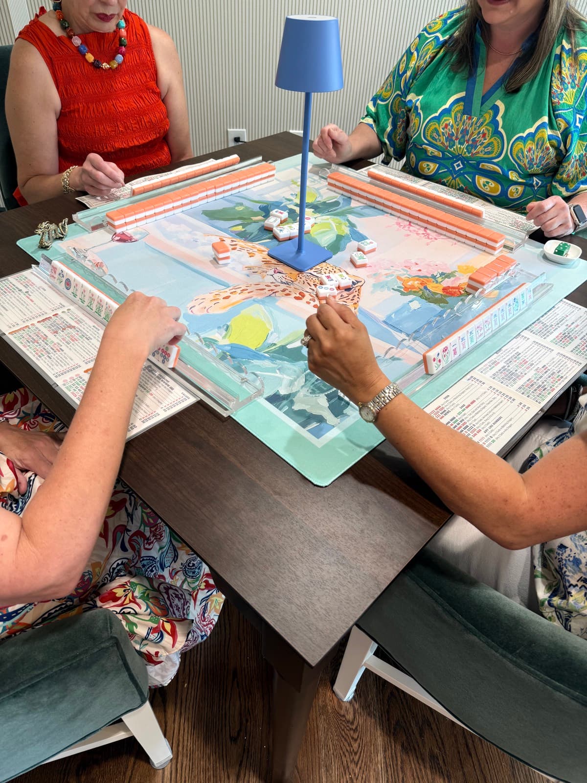 Players enjoying American mahjong at a styled table in Golden Triangle.