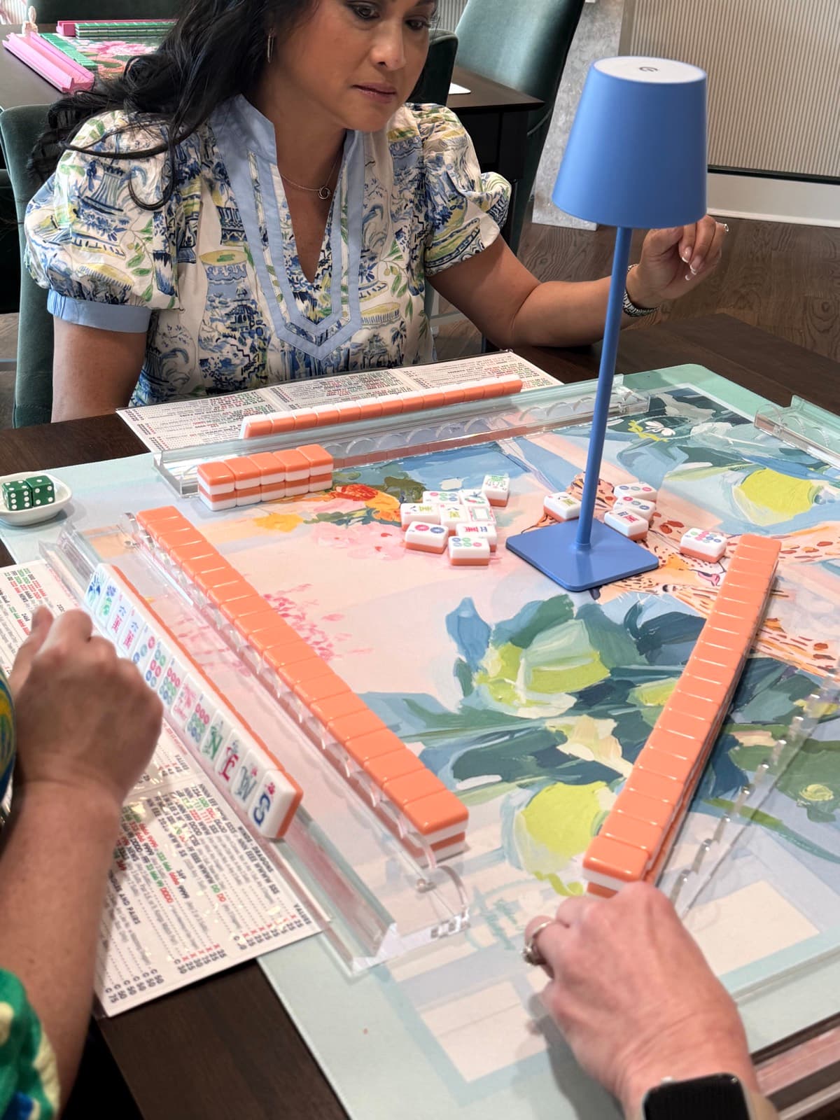 Players enjoying American mahjong at a styled table in Hattiesburg.